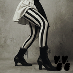 Black and white bold vertical stripe leggings by YéYé, styled with a black and white puff sleeve mini dress and black Victorian lace-up heeled boots