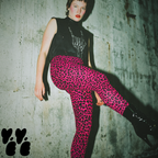 A female model wearing studio yeye hot pink leopard leggings, punk t-shirts and patent leather pin-up boots at old warehouse.
