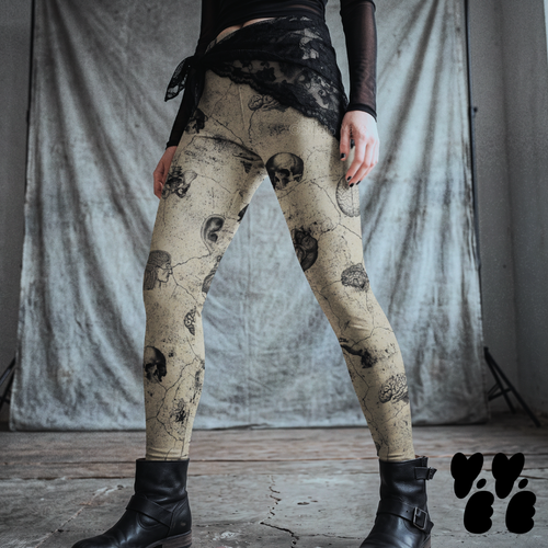 Model wearing skull beige vintage anatomical leggings with skulls, brains, and other anatomical illustrations, styled with black boots.