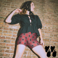 A vintage circus core style model wears mid century style diamond pattern bike shorts with puff sleeve tops