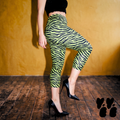 A female model wears high waisted tiger-zebra printed lime green capri pants with heels with spikes and mohair top.