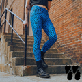 A hipster man wears cheetah printed mens leggings royal blue, with cropped t-shirts and combat boots.
