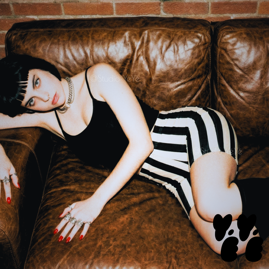 A hipster woman wears black camisole with black and white striped bike shorts by studio yeye