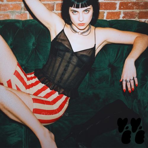 A hipster female model wears see through bustier camisole with red and vintage off white striped bike shorts