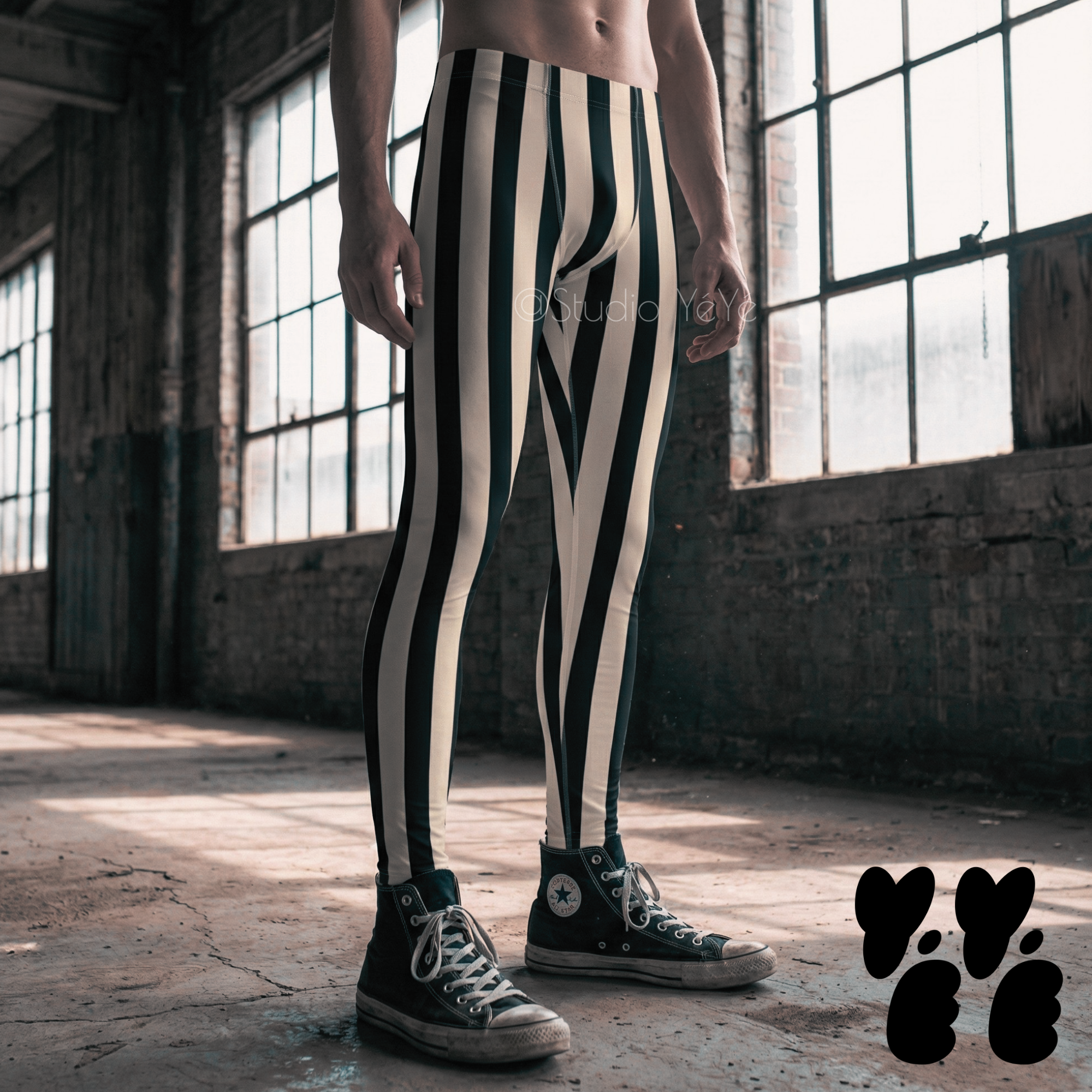 a male dancer wears bold black and white striped leggings-tights for men with converse shoes at industrial location in Los Angeles