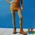 A woman wearing studio yeye doodle stripe leggings in mustard and blue, with sheer mustard dress with suede half boots 