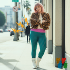 A plus size pink hair female model wears 2XL wears small polka dot legging in mint green and pink, with leopard jacket and 80s vintage white boots