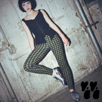 A woman wears studio yeye's gingham leggings moss green black with vivianne westwood tops and silver shoes