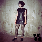Black and white gingham leggings by YéYé, styled with a white oversized top and two-tone saddle shoes at night in a park