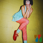 Red and white gingham leggings with pastel blue colour-blocked ankle by YéYé, styled with a mint ruffle peplum top and red lace-up ballet flats against a yellow wall