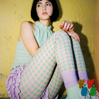 Mint and pink gingham leggings with lavender colour-blocked ankle by YéYé, styled with a mint smocked halter top and lavender ruffle skirt against a yellow wall