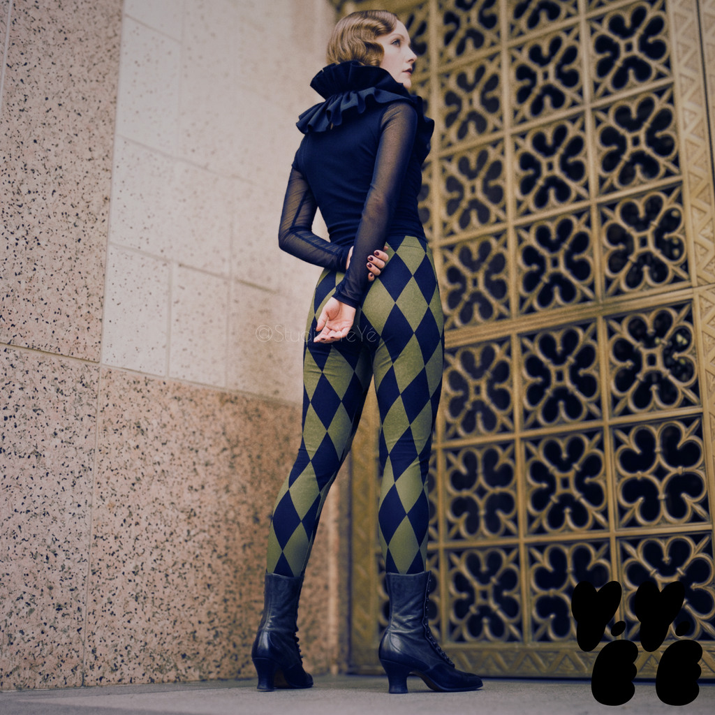 A 1930's style classic female model wears harlequin diamond pattern in moss green tights with vintage clown-core style in downtown Los Angeles