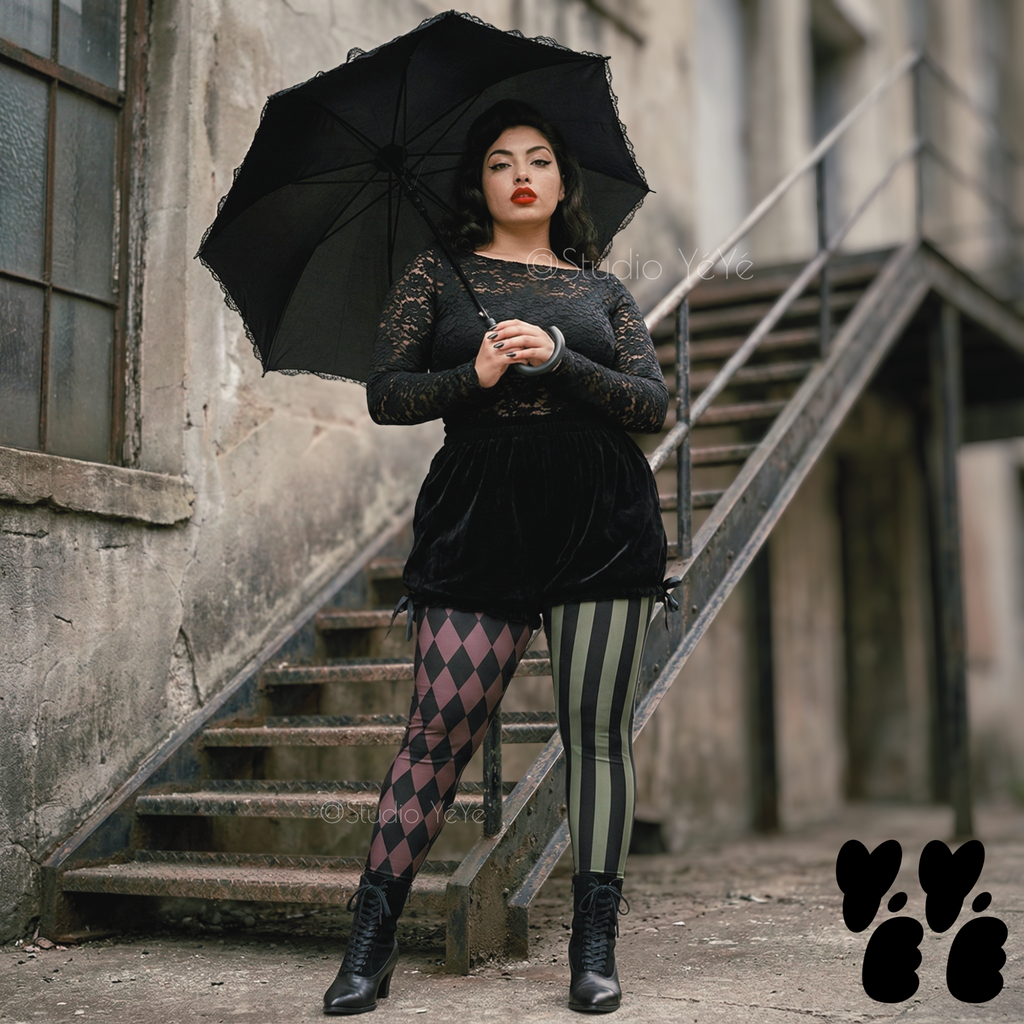 A plus size model wears black broomer, vintage lace top with jester leggings in olive and maroon, with victorian boots, goth punk vibe.
