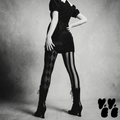 Mismatched harlequin diamond and stripe leggings in silent film grayscale by YéYé, styled with a black puff sleeve mini dress with white lace collar and black lace-up heeled boots