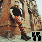 a female model wears size XXL harlequin jester leggings in red and black