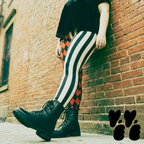 A plus sized female model wears harlequin jester leggings with combat boots