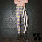 A make model wears harlequin jester printed leggings, vintage purple and acid green, black and off white stripe mix with dr marten boots.