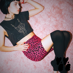 A hipster - punk female model wears punk cropped t-shirts with studio yeye leopard print bike shorts in hot pink