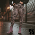 A plus sized female model wears 2XL leopard leggings in mauve pink