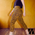 a model wears mustard yellow leopard animal printed cropped pants