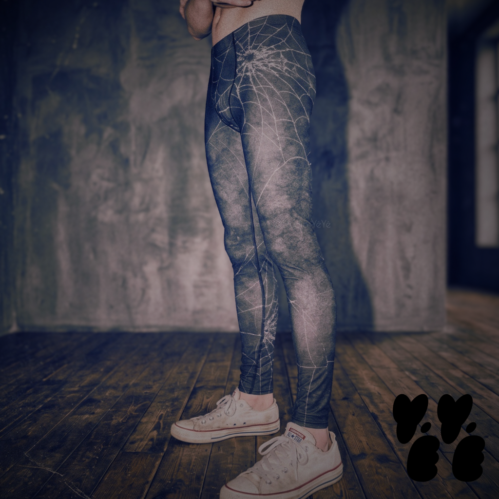 A male model wears dark web printed mens leggings with used converse. Halloween goth vibe. 