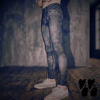A male model wears dark web printed mens leggings with used converse. Halloween goth vibe. 