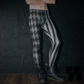 A mens model wears jester harlequin pattern leggings with grayscale, silent film costume 