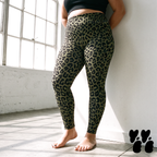 A plus size woman wears leopard high waist leggings in olive green and black.