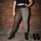 Model wearing brown and black harlequin diamond and fine pinstripe leggings with a dark lace top and black boots.
