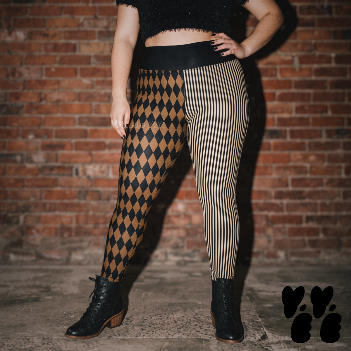 Model wearing brown and black harlequin diamond and fine pinstripe leggings with a dark lace top and black boots.