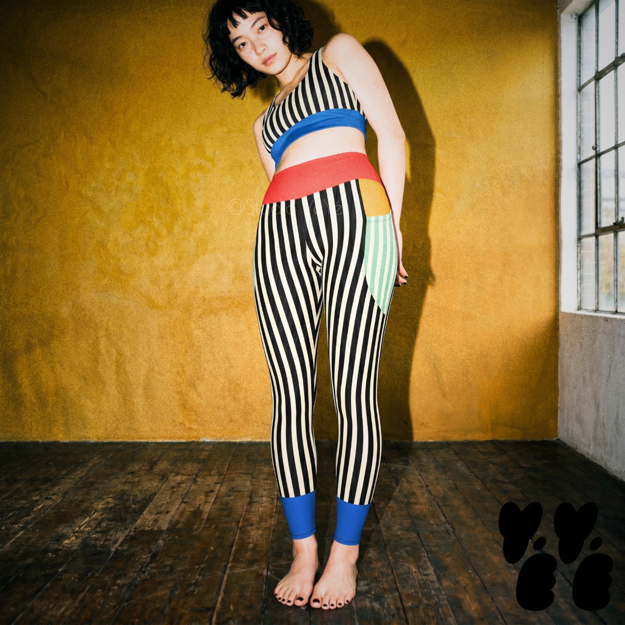 A japanese hipster woman wears bold striped yoga leggings with deep pockets