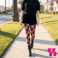 Dusty rose and black diamond check leggings with heart accents by YéYé, styled with a black pearl-embellished cable knit sweater, black velvet shorts and black lace-up ankle boots