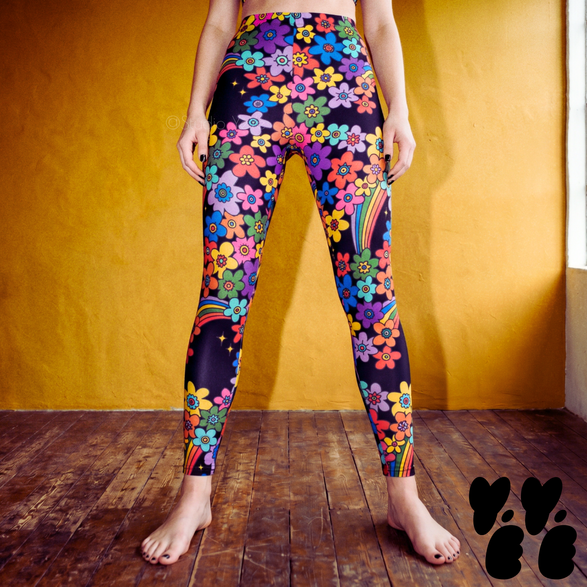 A female model wears unisex retro floral pattern tights in rainbow color.
