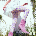 Sunny Bloom leggings in lavender and cream daisy print by YéYé, styled with a white lace mini skirt and pink cowboy boots