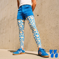A male model wears 60s floral print leggings in blue for men with corduroy summer shorts with blue adidas sneaker