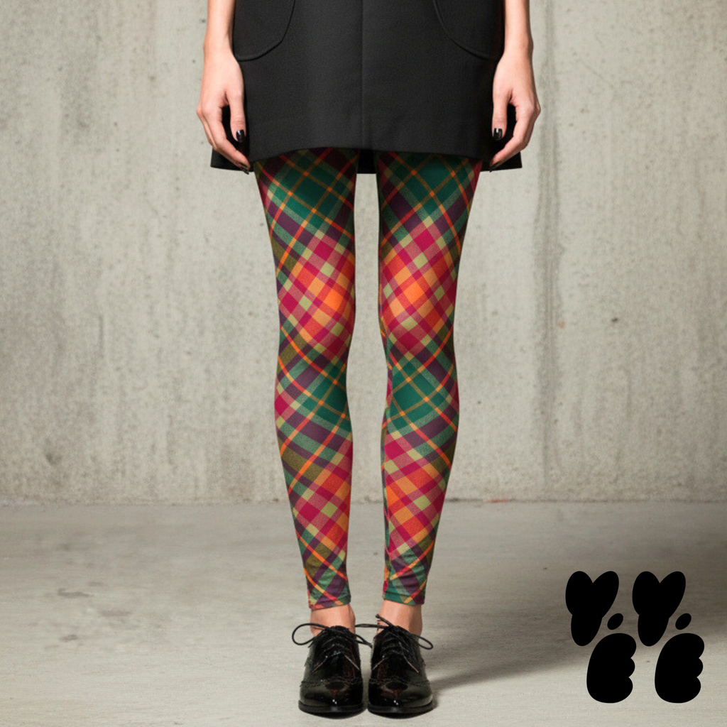 Oversized diagonal pink and green tartan leggings by YéYé, styled with a black sleeveless blazer dress and black brogue oxford shoes