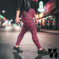 A plus sized female model wears 2XL tiger leggings in hot pink