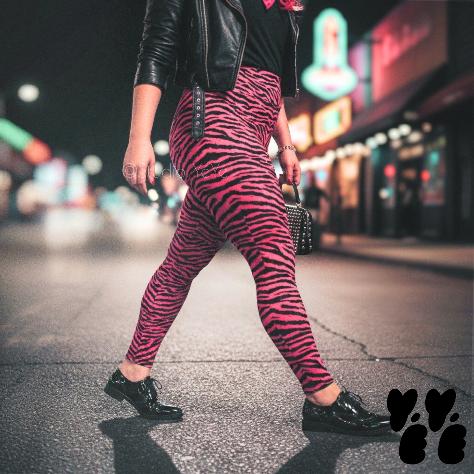 A plus sized female model wears 2XL tiger leggings in hot pink