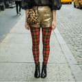 Retro red tartan plaid leggings by YéYé, styled with a black chiffon shirts, gold shorts, leopard bag with black patent leather studs boots at Soho in NYC.