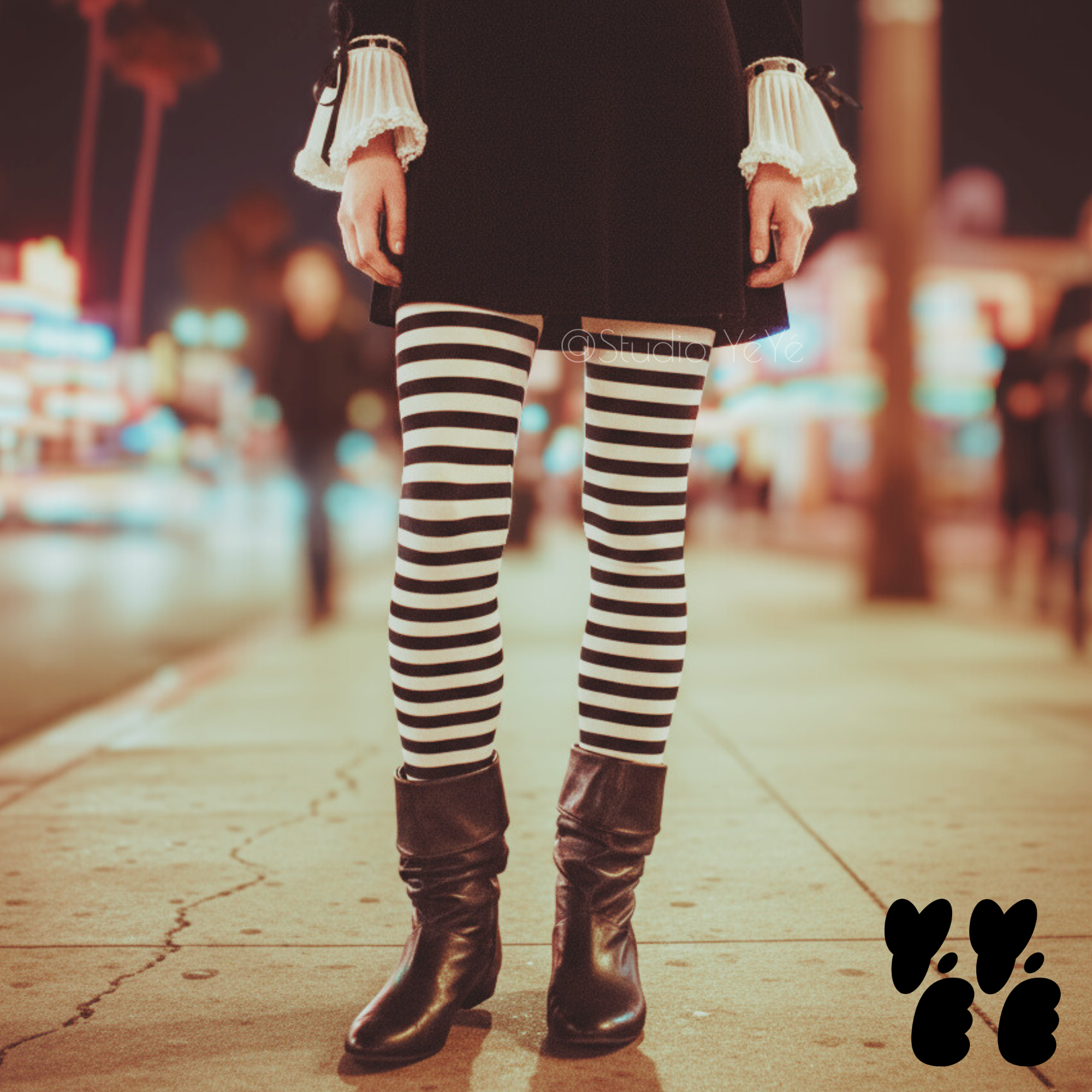 Black and white horizontal stripe leggings by YéYé, styled with a black mini skirt, white ruffle sleeve blouse and black slouch boots on a neon-lit city street at night