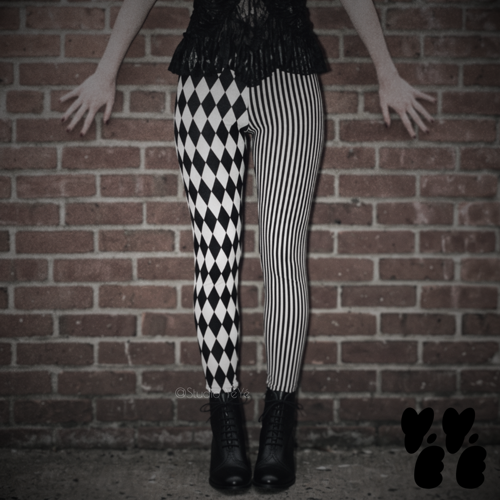 Model wearing black and white harlequin diamond and fine pinstripe leggings with a black lace top and black boots.