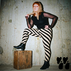 A hipster female plus size model wears diagonal bold stripe tights, 80's goth and punk vibe.